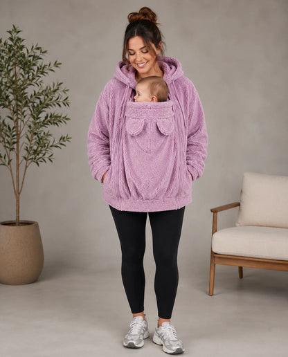Mother wearing the pink Everlittle SnuggleNest babywearing fleece hoodie with baby